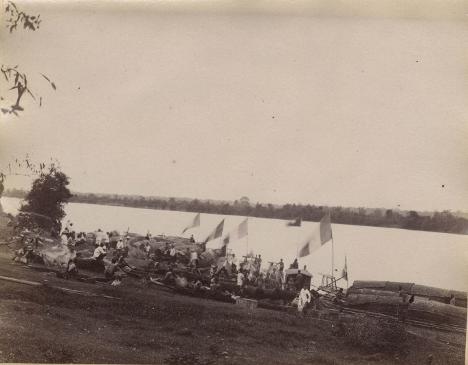 Boats, people and french flags on a river bank. black and white photograph